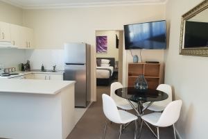 The Kitchen and Dining Area of Mayfield Short Stay Apartments.